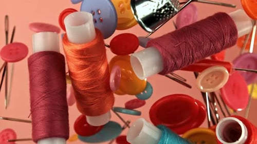 Colorful Sewing Notions Floating on Pink Background