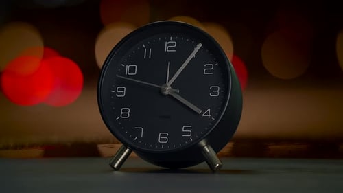 This is an Elegant Black Alarm Clock That Boasts a Classic Design with Timeless Appeal