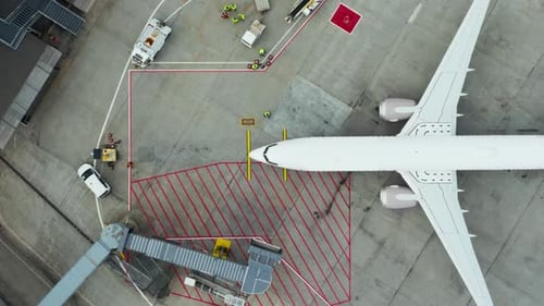 Top Down View Of Passenger Plane Parked At Airport Gate