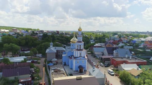 Orthodox Church with Golden Domes Under Cloudy Sky