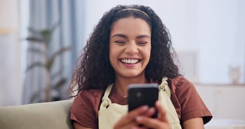 Woman, laughing and typing with phone on couch for text message, social media post