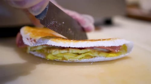 Cutting a Tapioca Crepe on a Cutting Board