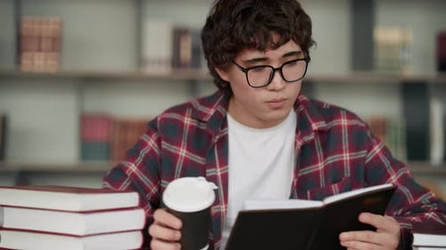 Young asian student studying in a university library