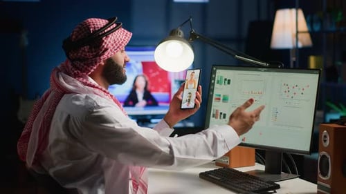 Man in Headdress Video Calling in Office