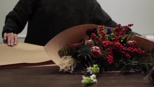 Florist arranging colorful bouquet at flower shop