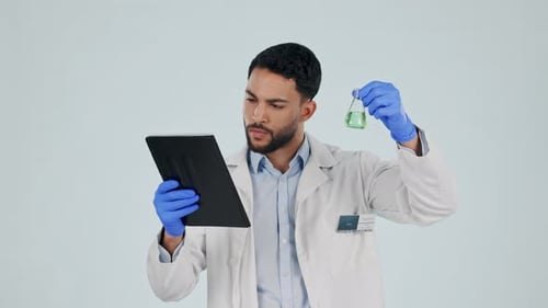 Man, tablet and science beaker in studio for healthcare study, chemistry development