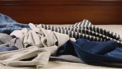 Pile of Clothes on Bed