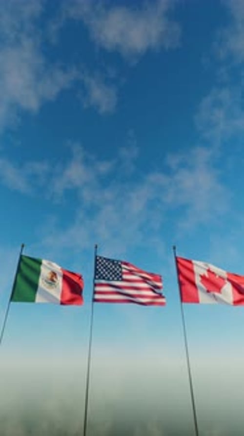 Flags of USA Mexico and Canada Waving Under Blue Sky