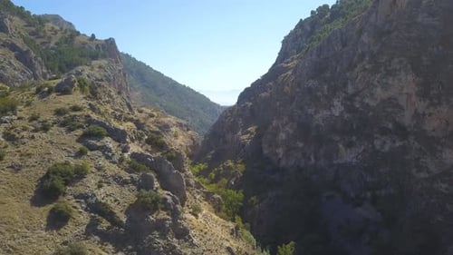 Aerial revealing shot of big rocky mountains in the south of Spain on a summer day.