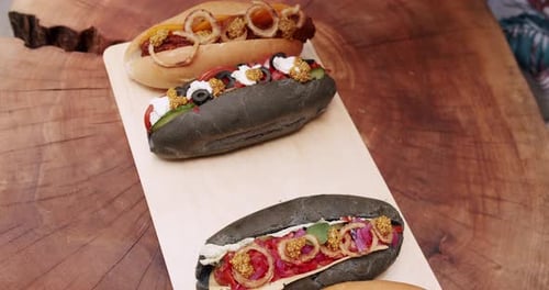 Variously Topped Gourmet Hotdogs on a Wooden Board
