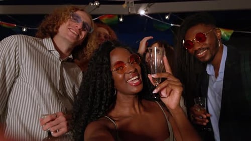 Friends Celebrating at Night with Champagne Glasses