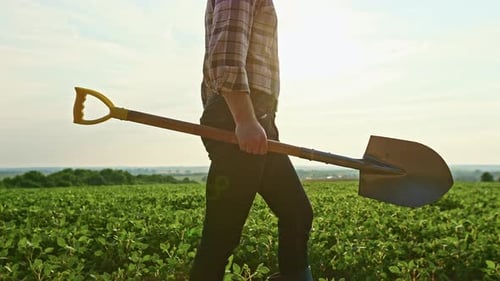Farmer Holding Spade Walking Digging in Field