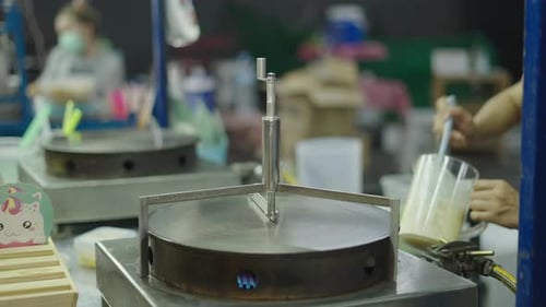 Street Food Vendor Cooking Crepe on Hot Griddle