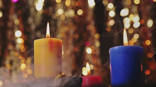 Burning Candles with Glowing Bokeh Lights Background