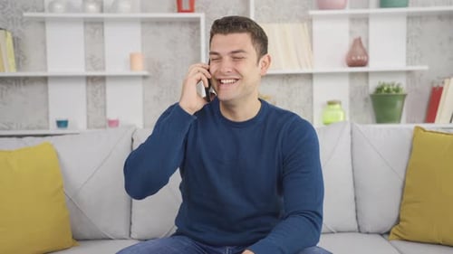 Man Talking on Phone Sitting on Couch