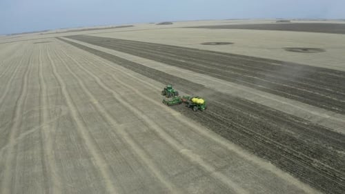 Tractor Farming Field in Rural Agriculture Aerial