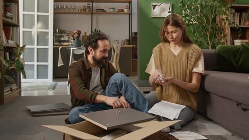 Mature Couple Inserting Fixtures on Drawer Panel during DIY Assembly