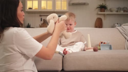 Woman and Child Playing with Stuffed Animal