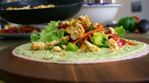 Chopped Scrambled Eggs Dropping Onto Pita Bread With Fresh Vegetables. Egg Salad Pita. close up, slo