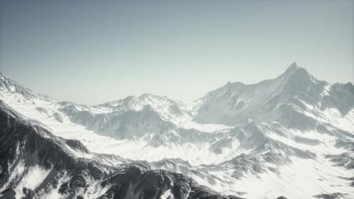 Cinematic Aerial View Over Majestic Snow-Capped Mountains