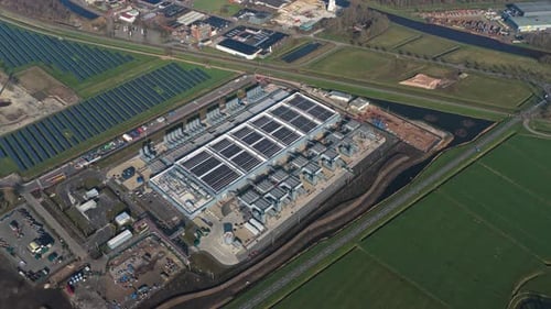 Aerial view of large datacenter with rooftop solar panels