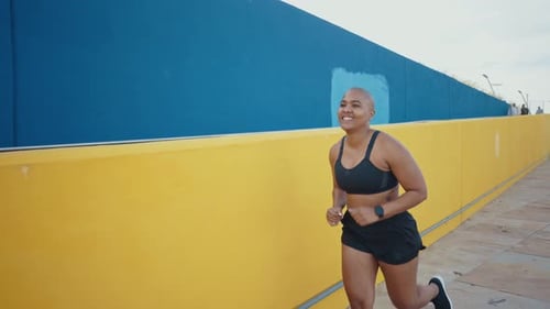Athletic Woman Jogging Happily Along Urban Street