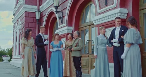 Group in Vintage Clothing Poses in Front of Building