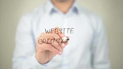 Man Writes Website Optimization on Clear Surface