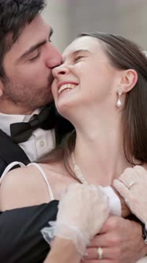 Newlyweds Embrace Affectionately in Elegant Wedding Attire