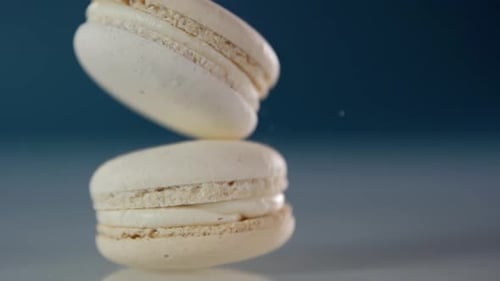 One macaroon falls on top of another macaroon in slow motion