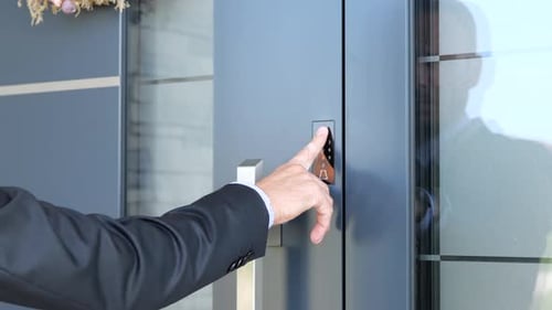 Man Scanning Fingerprint To Open The Door Of Smart Home. - close up shot