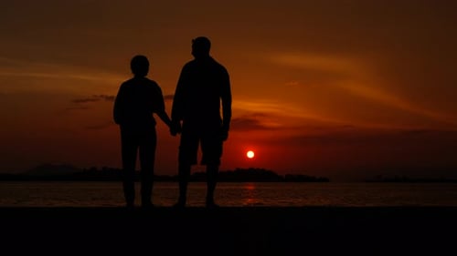 Lovely Couple Against Colorful River Evening