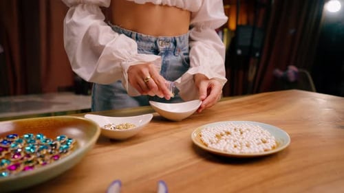 close-up female hands pouring out beautiful beads for a necklace or earrings the beauty of jewelry