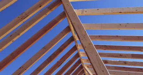 Wood Roof Framing Against Blue Sky