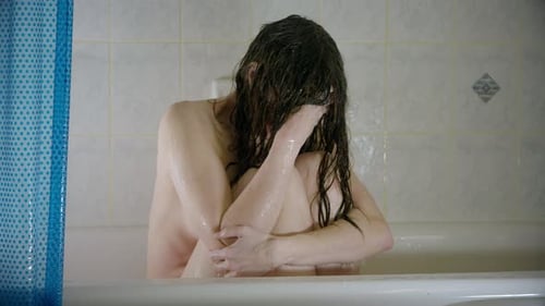 Woman Alone in Bathtub Suffering Emotionally