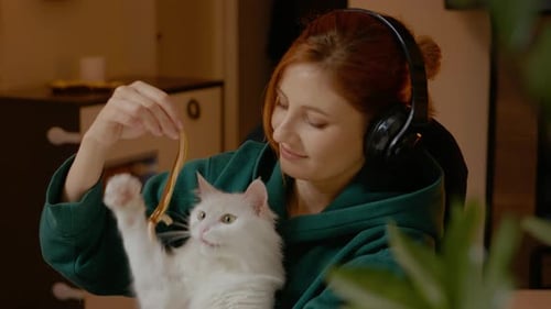 Enjoying music and quality time with a white cat at home
