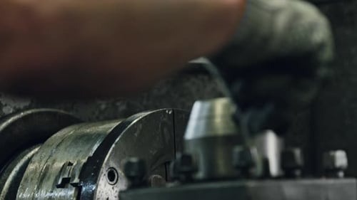 Precision lathe operation by skilled worker in industrial setting