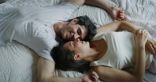 Cinematic close up shot of young couple in love is relaxing in the bedroom in the early morning in