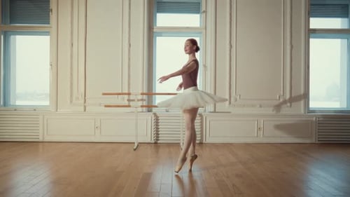 Auburn Haired Ballerina Dancing Elegantly in a Studio