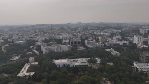 Aerial shot of a central Hyderabad landmark with nearby roads and traffic movement.