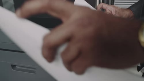 Faceless Office Worker Scanning Documents at Work