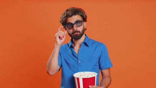 Young Adult Eating Popcorn Wearing 3D Glasses