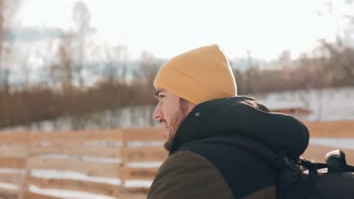 Man Walking in Snowy Rural Winter Weather