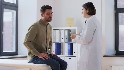 Doctor Listening to Patient with Stethoscope Indoors