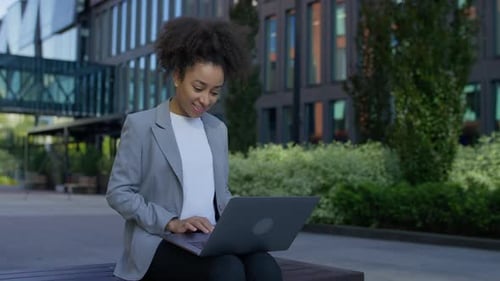 Young Professional Using Laptop Outdoors in City