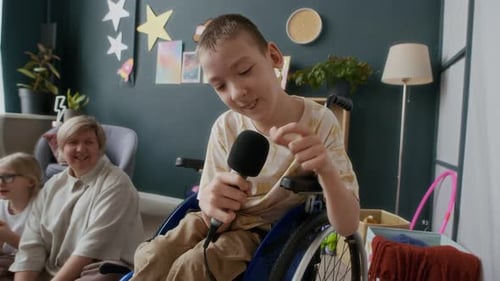 Boy Singing into Microphone in Wheelchair
