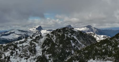 Snowy Mountain Peaks Under Cloudy Sky. British Columbia, Canada.