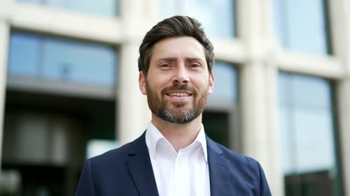 Man Smiling Outside Corporate Office Building