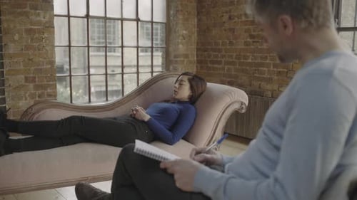 Counselling session, Adult Female Talking to Counsellor on psychiatrist couch