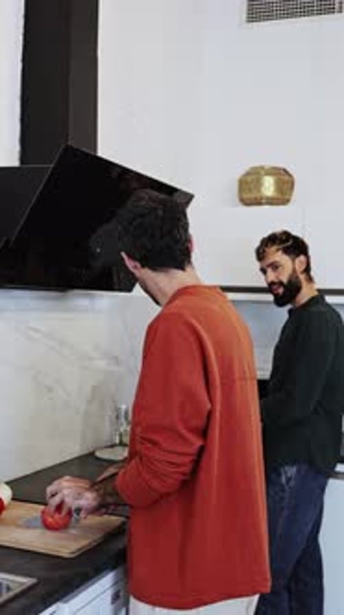 Young Adults Cooking Tomato in Home Kitchen